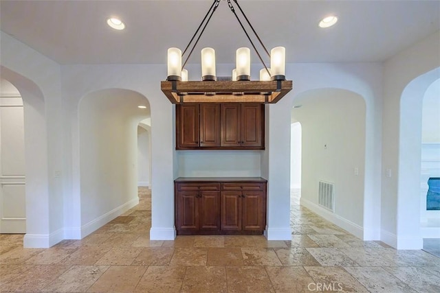 unfurnished dining area featuring a chandelier