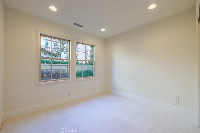 empty room featuring light colored carpet