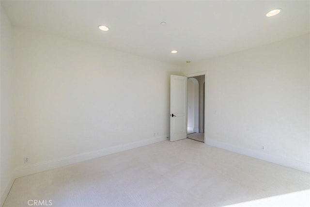 unfurnished room with light colored carpet