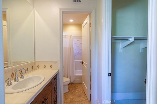 full bathroom with toilet, vanity, shower / bathtub combination with curtain, and tile patterned flooring