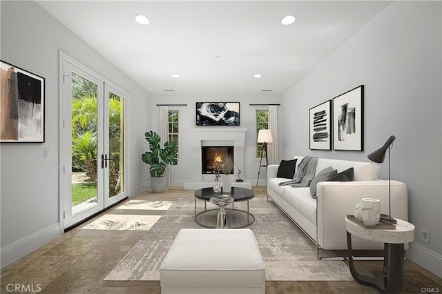 living room featuring plenty of natural light and french doors