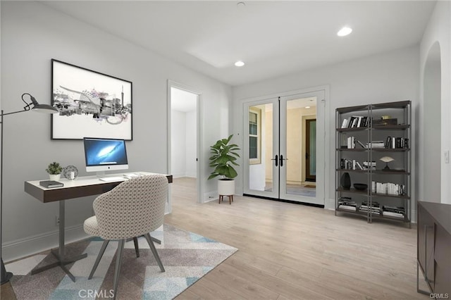 office space featuring french doors and light hardwood / wood-style flooring