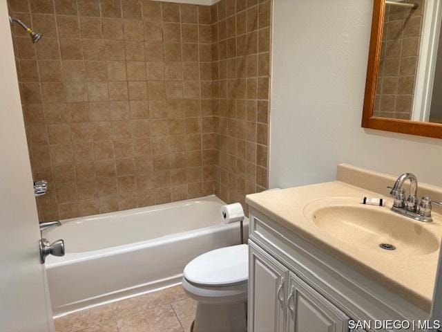 full bathroom with toilet, tiled shower / bath, tile patterned flooring, and vanity