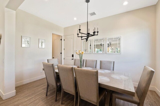 dining area with a chandelier and hardwood / wood-style flooring