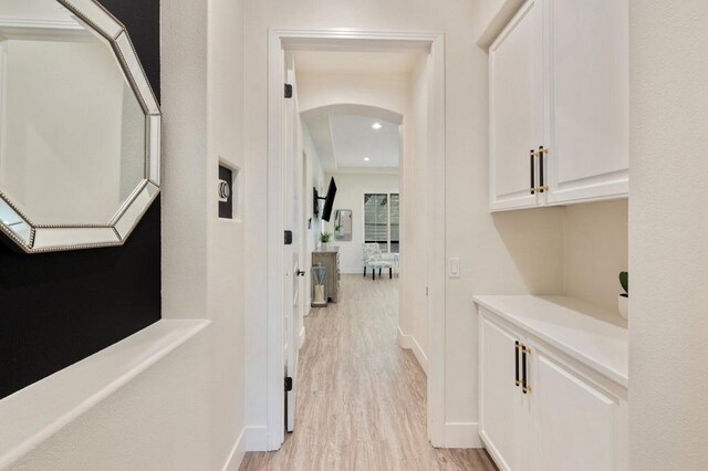 hallway with light hardwood / wood-style flooring