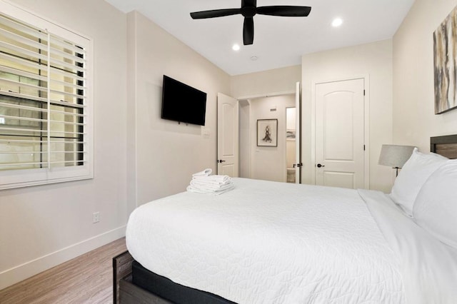 bedroom featuring ceiling fan, light hardwood / wood-style floors, and a closet