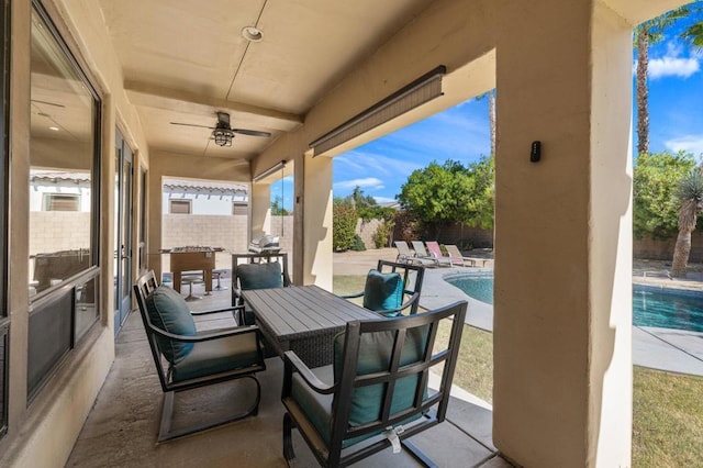 view of patio / terrace with ceiling fan and a fenced in pool