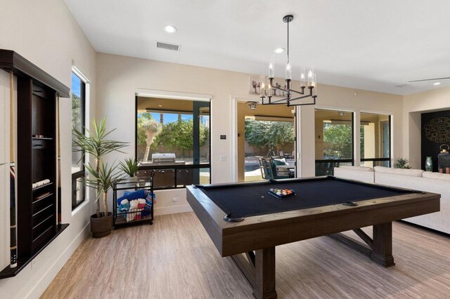 game room with billiards, an inviting chandelier, and hardwood / wood-style floors