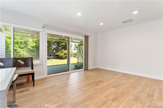 spare room featuring light hardwood / wood-style floors