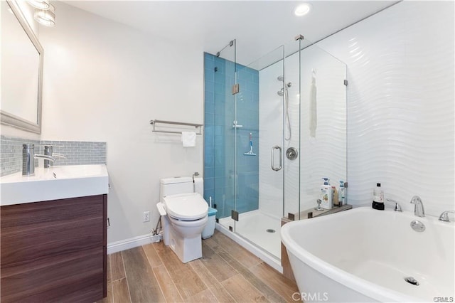 full bathroom featuring toilet, vanity, and shower with separate bathtub