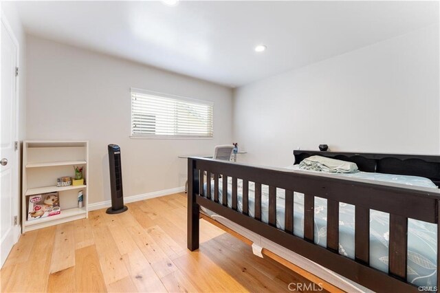 bedroom with hardwood / wood-style flooring