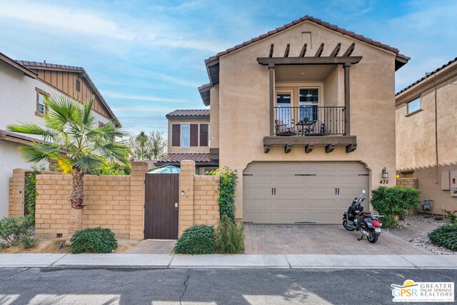 view of front of house featuring a balcony and a garage