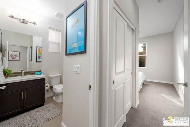 bathroom featuring toilet and vanity