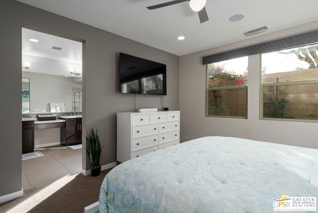 bedroom with ceiling fan, sink, ensuite bath, and light tile patterned flooring