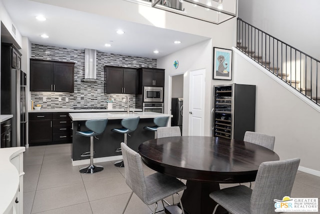 tiled dining area featuring wine cooler and sink