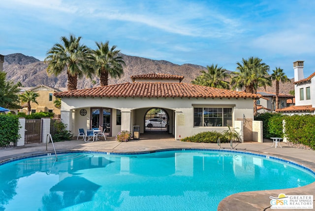 view of pool featuring a mountain view and a patio