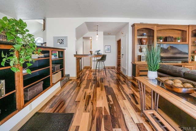 hallway featuring a textured ceiling and hardwood / wood-style floors