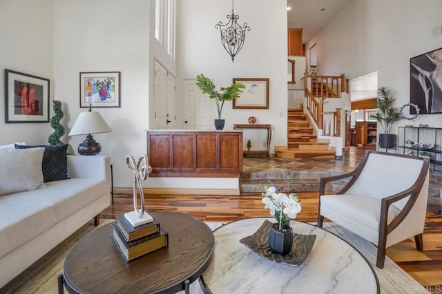 interior space with a towering ceiling and light hardwood / wood-style flooring