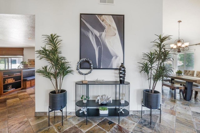 interior details with a textured ceiling and a notable chandelier