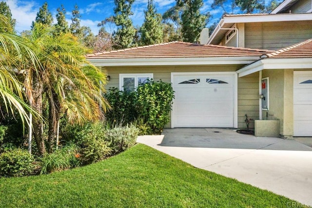 view of home's exterior with a garage and a lawn