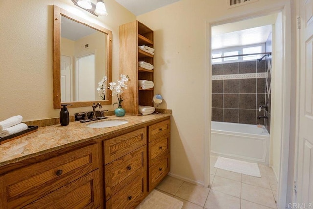 bathroom featuring tiled shower / bath combo, vanity, and tile patterned flooring