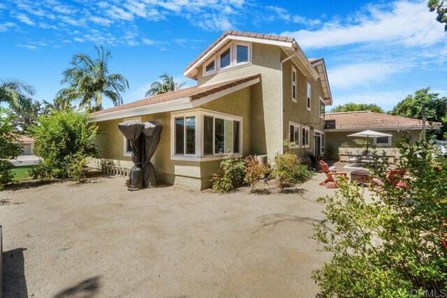 back of property with a patio area