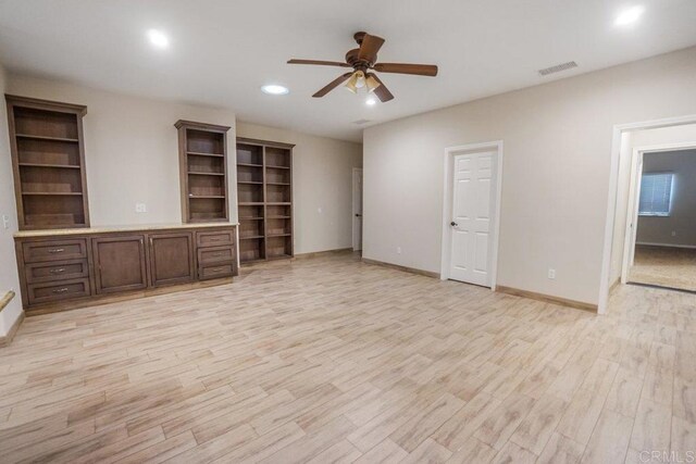 unfurnished living room with ceiling fan and light hardwood / wood-style floors