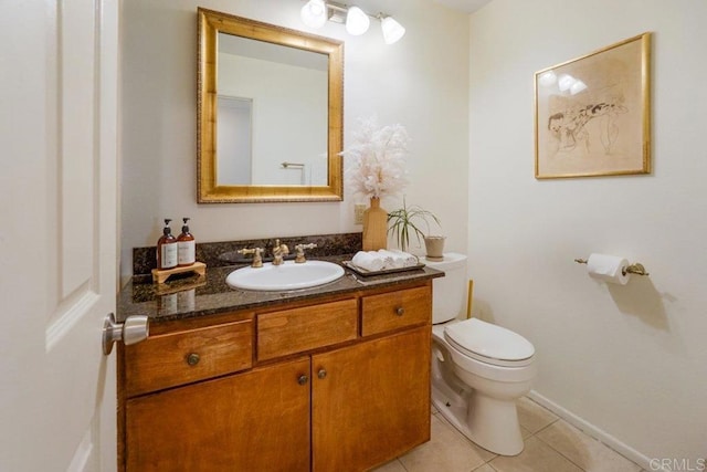 bathroom featuring toilet, vanity, and tile patterned flooring