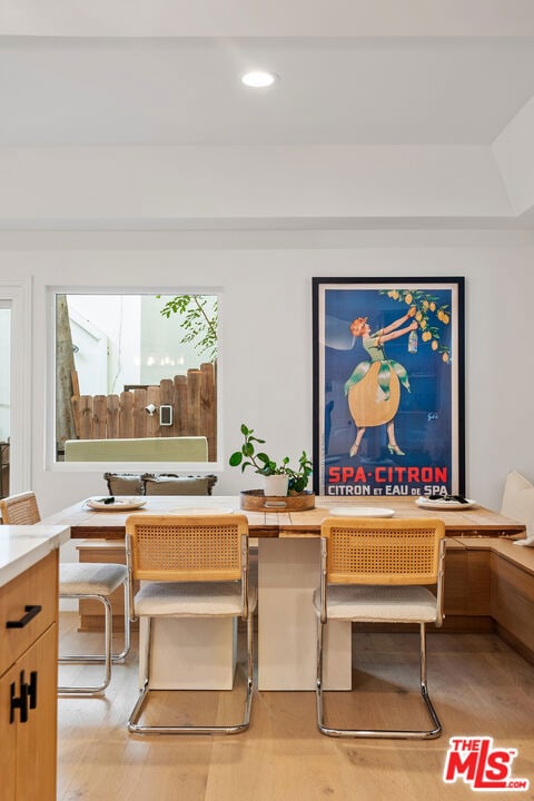 dining room with a wealth of natural light and light wood-type flooring