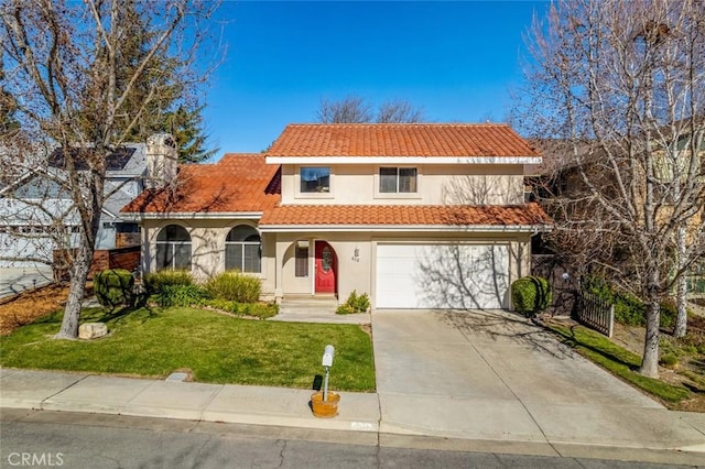 mediterranean / spanish-style house with a garage and a front lawn