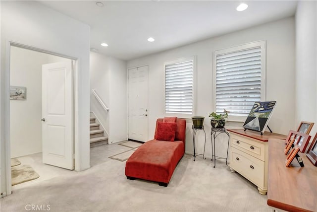 sitting room featuring light colored carpet