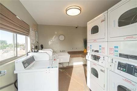 clothes washing area featuring stacked washing maching and dryer and independent washer and dryer