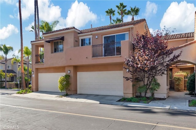 view of front of house featuring a garage and a balcony