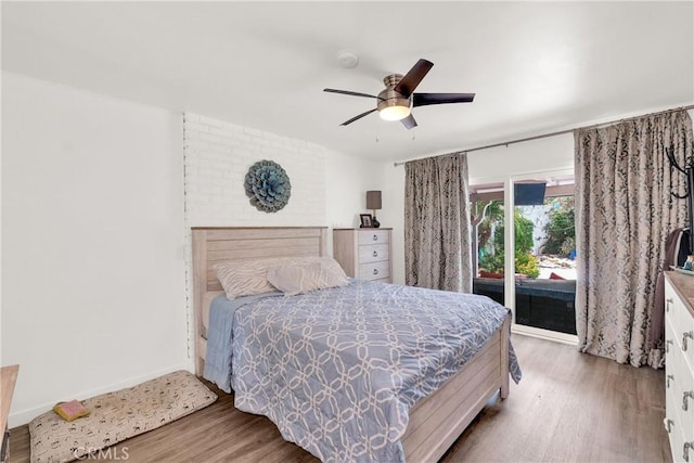 bedroom featuring ceiling fan, access to exterior, and wood-type flooring