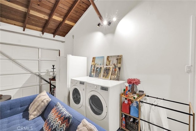 laundry room with washer and clothes dryer, wood ceiling, and a towering ceiling