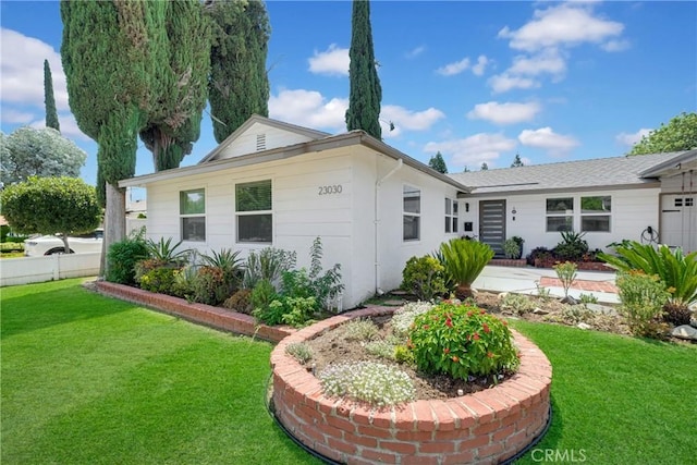 back of house featuring a lawn