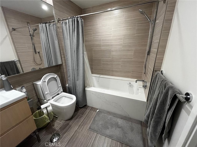 full bathroom featuring toilet, vanity, and shower / bathtub combination with curtain