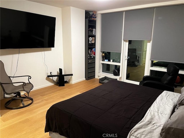 bedroom with a closet and light hardwood / wood-style floors