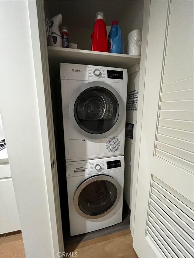 laundry area featuring stacked washer / drying machine