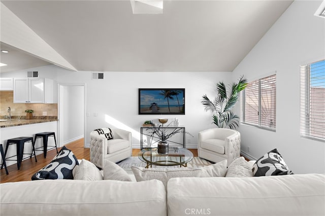 living room with dark wood-type flooring and vaulted ceiling