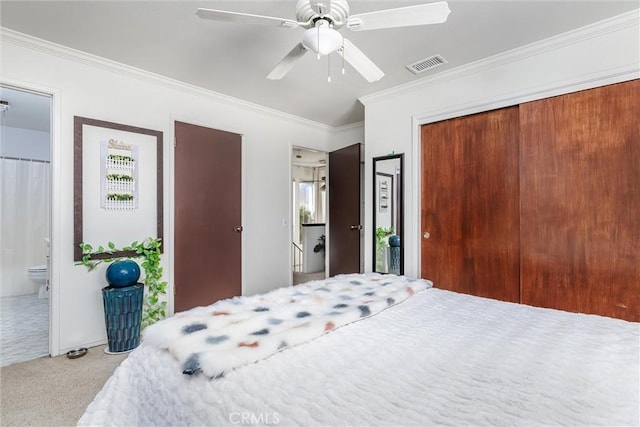 bedroom with ceiling fan, crown molding, carpet floors, and ensuite bath