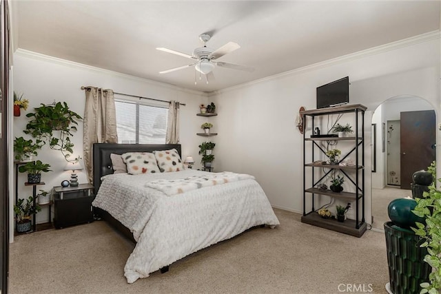 bedroom featuring ceiling fan, light colored carpet, and crown molding