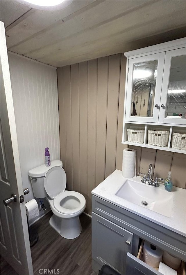 bathroom featuring vanity, wood ceiling, and wood walls