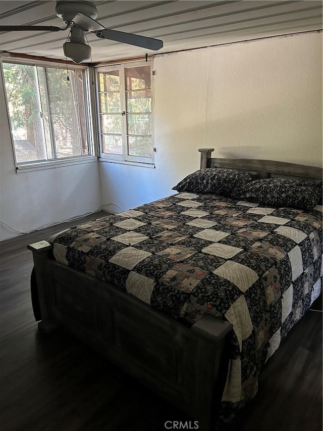 bedroom featuring ceiling fan and dark wood-type flooring