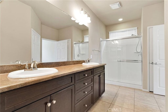 bathroom with tile patterned flooring, a shower with shower door, and vanity