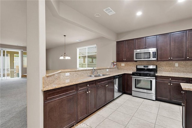 kitchen featuring a chandelier, kitchen peninsula, sink, and stainless steel appliances