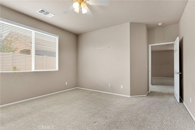 spare room with light carpet and ceiling fan