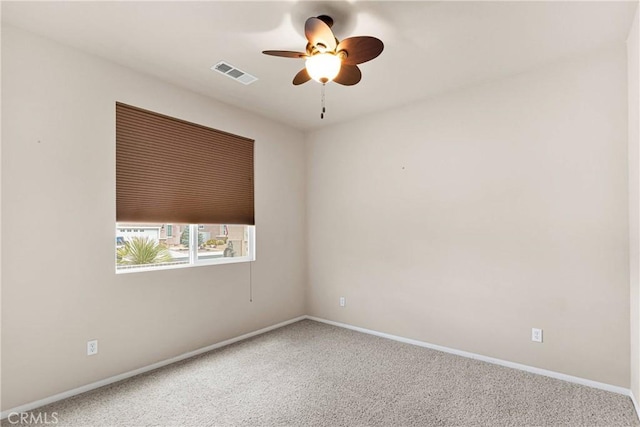 spare room with carpet floors and ceiling fan