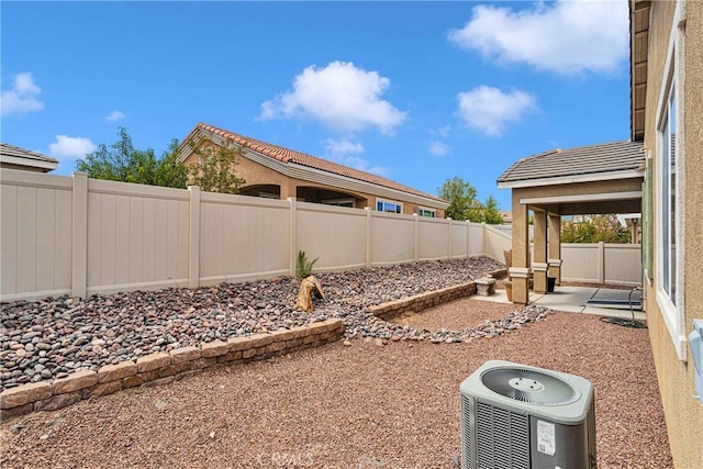 view of yard featuring central AC and a patio area