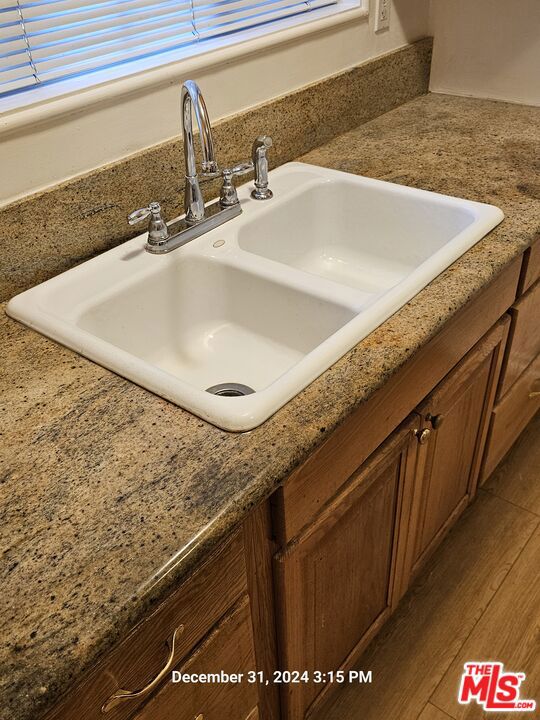 room details featuring sink and wood-type flooring